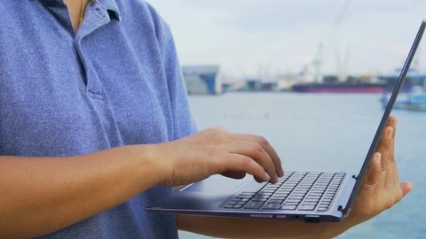 Slow motion, Young foreman using laptop check product at commercial port Stock Footage 123140838