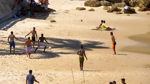 Slow motion of Young guys playing soccer at primeira praia beach in Bahia Stock Footage 149766429
