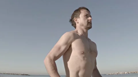 Slow motion: Young half naked man running along the beach. Original 스톡 동영상 58252722
