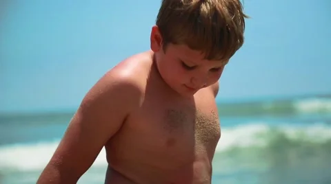 Slow motion of young kid at the beach looking at the camera Stock Footage 63887278