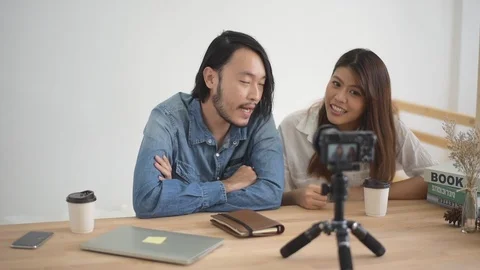 Slow motion, Young man and woman are talking with the camera at home 動画素材 108738130