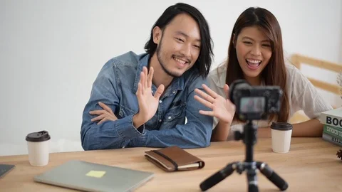 Slow motion, Young man and woman are waving the hand with the camera 動画素材 108738208