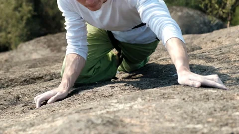 Slow motion of a young man climbing a rock wall without insurance. Stock Footage 130912591