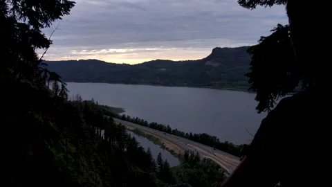 Slow motion of young man looking at the columbia river gorge from Multnomah Stock-Footage 245782323