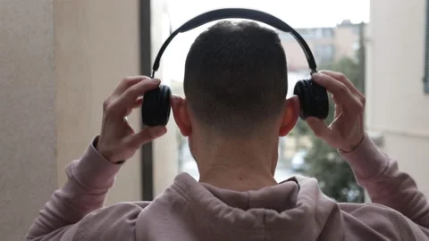 Slow motion of young man putting on headphones Stock Footage 170962384