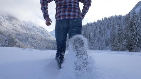 Slow motion - Young man running in fresh snow Stock Footage 96582013