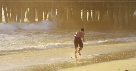 Slow motion of a young man skimboarding. Stock Footage 73334747