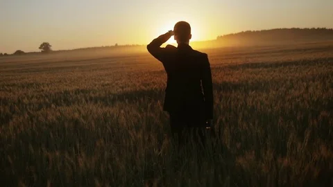 Slow motion of young man in suit looking ahead at the sun Stock Footage 71928093