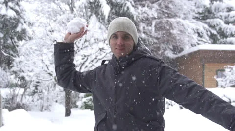 SLOW MOTION: Young man throwing a snowball Stock Footage 22554077