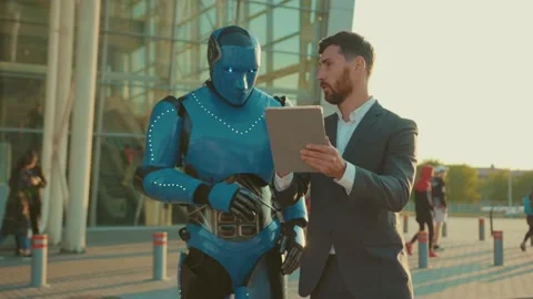 Slow motion young man use tablet computer talking with humanoid robot shows the Stock Footage 133299465