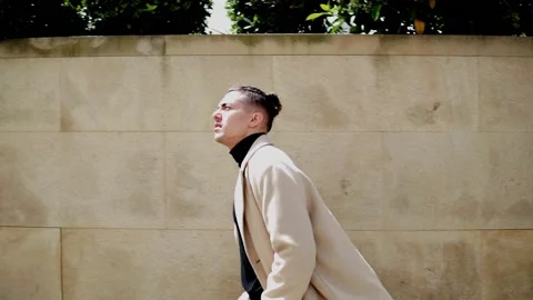 Slow motion of a young  man walking in the city Stock Footage 200582279