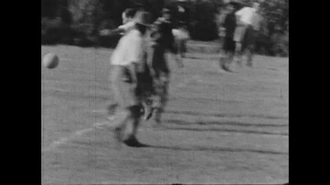 Slow motion of young men playing football, United Kingdom, 1932 to 1936 Video stock 131531071