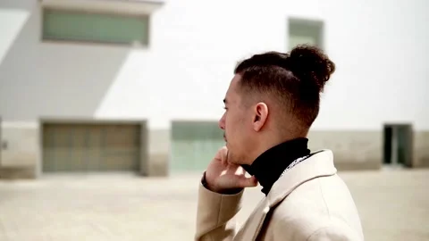Slow motion of a Young mixed race man talking on a smartphone in the city. Stock Footage 182925151
