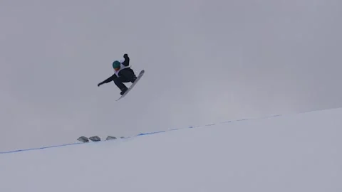 SLOW MOTION: Young pro snowboarder big air Stock Footage 144495112