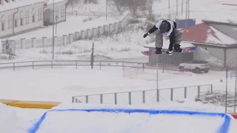 SLOW MOTION: Young pro snowboarder big air Stock Footage 144496142