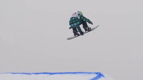 SLOW MOTION: Young pro snowboarder big air Stock Footage 144496348