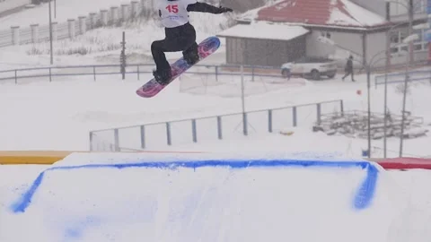 SLOW MOTION: Young pro snowboarder big air Stock Footage 144496384