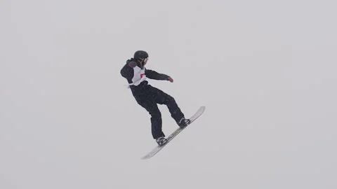 SLOW MOTION: Young pro snowboarder big air Stock Footage 144496449