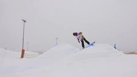 SLOW MOTION: Young pro snowboarder big air Stock Footage 144496604