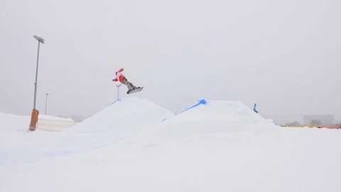 SLOW MOTION: Young pro snowboarder big air Stock Footage 144496865