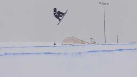 SLOW MOTION: Young pro snowboarder big air Stock Footage 144497347