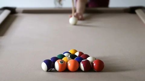 Slow motion of young woman bending over, doing break shot of pool billiard game Stock Footage 96996853