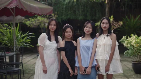 Slow motion zoom in four young asian teenage girls wearing summer dresses and Stock Footage 275082696