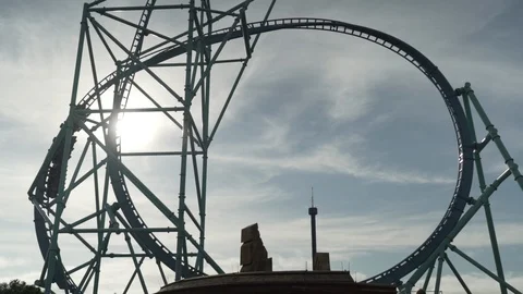 Slow motion zoom in shot of roller coaster ride against sky, California Stock Footage 121710793
