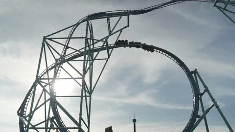 Slow motion zoom in shot of roller coaster ride against sky, California Stock Footage 121711333