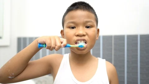 Slow motion,Asian boy brushing his teeth in bathroom. Stock Footage 113286232