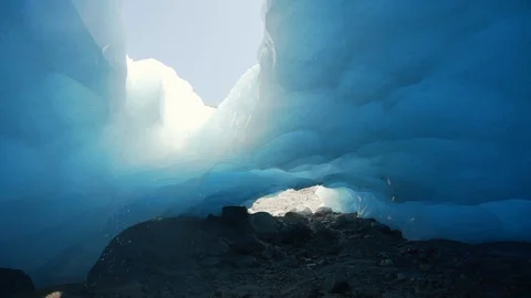 Slow Motion/Exit of Water Dripping Through Sunny Hole In Roof Of Glacier - Stock Footage 113946573