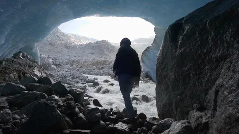 Slow Motion/Forward of Walking On Rocky Ground Inside Glacier Cave By Flowing Stock Footage 113949485