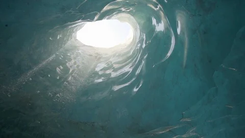 Slow Motion/Pan Down of People Walking Through Glacier Cave, Sunny Holes Above - Stock Footage 113948603