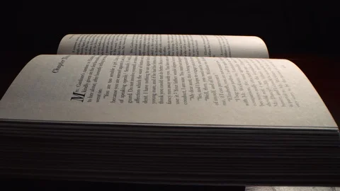 Slow move across open book from the side, sweeping right over printed words RED Stock Footage 122605235