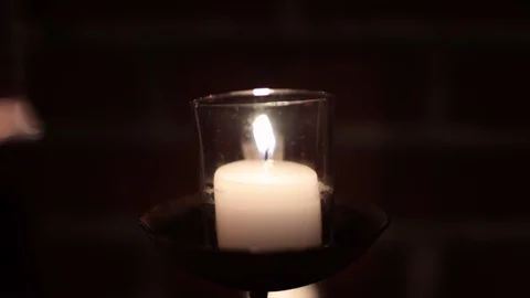 Slow move away from tiny candle in dark 스톡 동영상 97096182
