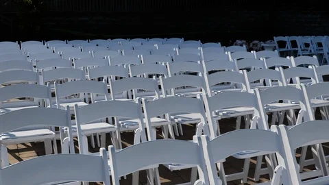 Slow move back over many white wedding chairs Video stock 114185961