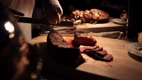 Slow move to chef cutting large beef cutting board 動画素材 100723383
