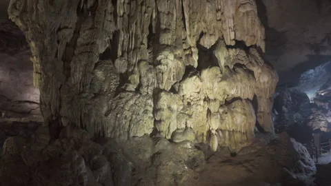 Slow move left orbit shot inside cave at Ha Long Bay Видео 287211513