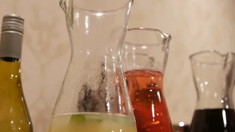 Slow move over bottles of different colored juices 스톡 동영상 107247553