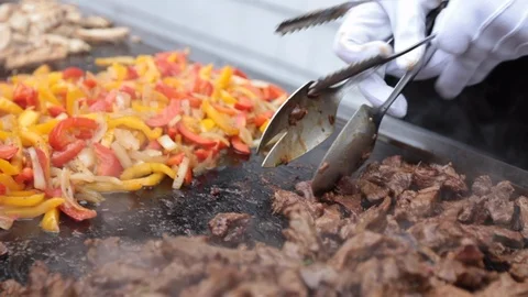 Slow move over textured delicious sizzling meat on skillet Stock-Footage 107936150