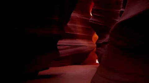 Slow move through dark interior of narrow slot canyon Stock Footage 329559873