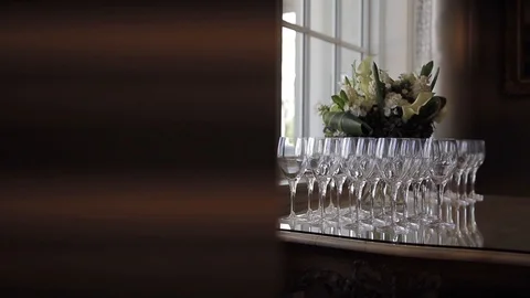 Slow move towards elegant wine glasses next to window Stock Footage 127053945