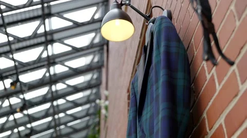 Slow move underneath blue green plaid suit jacket hanging Stock Footage 160072790
