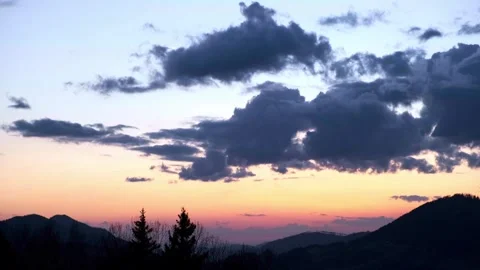 Slow movement of clouds in the sky, Hilly landscape at dusk Video stock 268702570