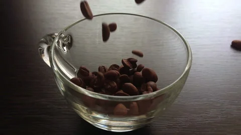 Slow movement of coffee beans falling into a glass Stock Footage 88668564