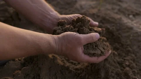 The slow movement of a hand lightly touching the clay soil, the farmer checks 스톡 동영상 201158281