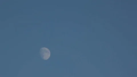 Slow movement of the Moon on the blue sky Stock Footage 78545468