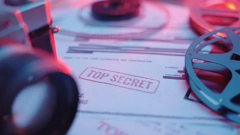 Slow movement on various papers on desk with official Top Secret red stamp Stock Footage 240649349