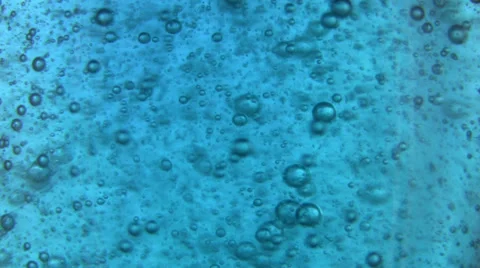 Slow moving bubbles in blue liquid texture Stock Footage 35062117