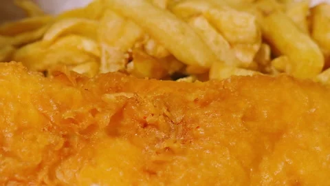 Slow Moving Camera View Over Traditional British Fish and Chips Meal in Stock Footage 322557537